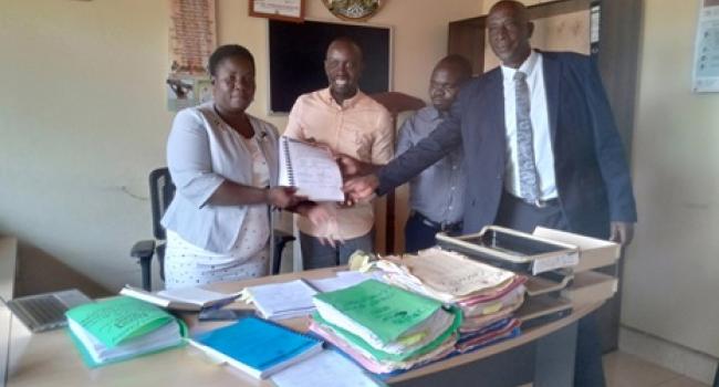 The CAO Tappy Namulondo (Extreme Left) Posing for a Photo with The District Vice Chairperson (Extreme Right) after Signing the NOSP Roads Contract in Her Office